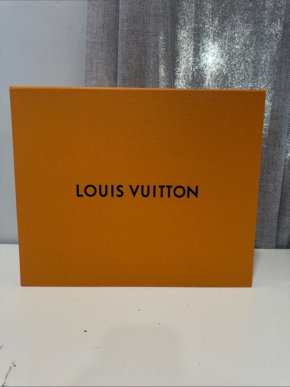 Authentic Louis Vuitton empty Orange Presentation Box with Black Logo.